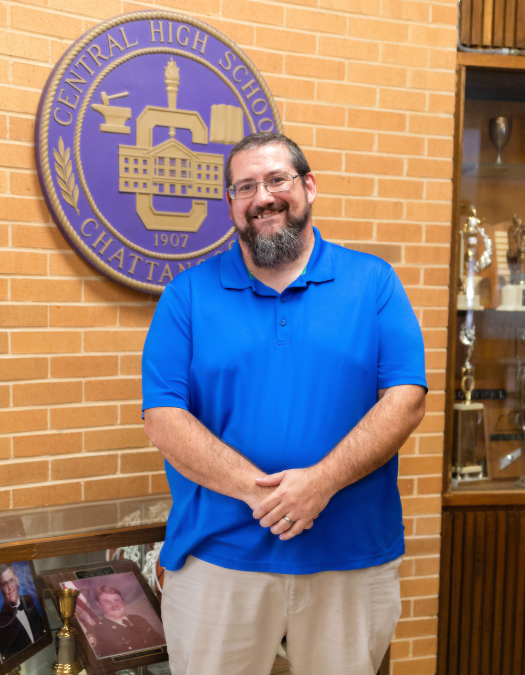 man standing in front of Central High logo