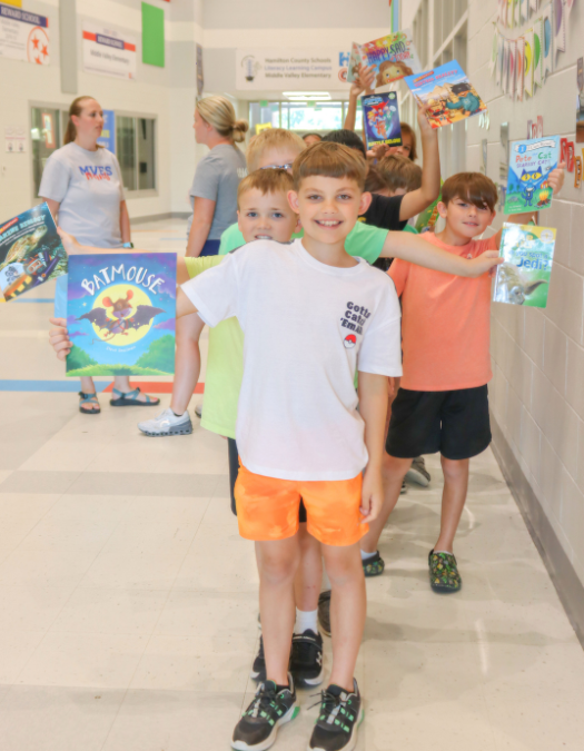 students holding books