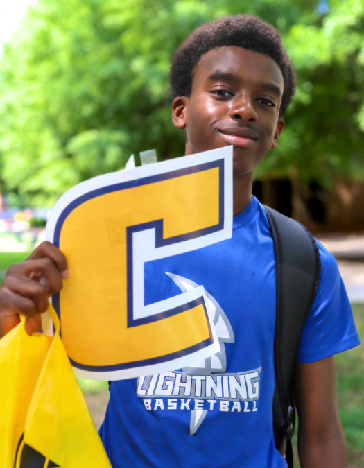 student posing for picture and smiling outside