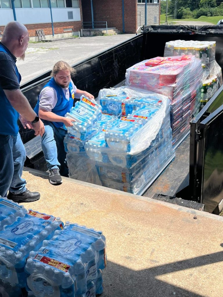 IMG_0719 Workers move bottles of water from a truck