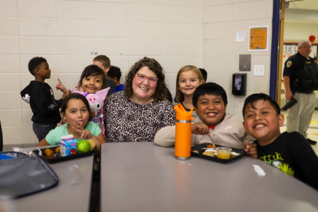 MM.PAM-14 A woman poses for a photo with students
