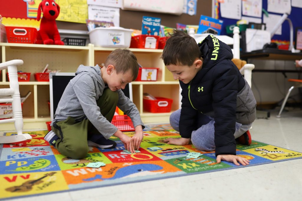 MccANDHixson-01 Two students play a game in a classroom