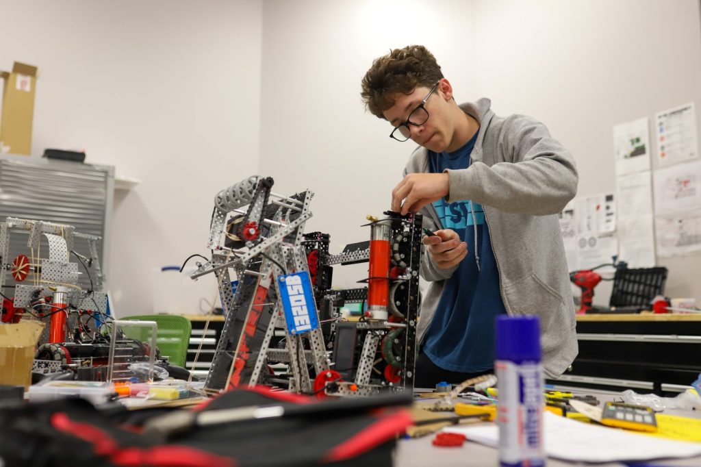 STEM.Visit-04 A student works on a robot